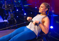 trainer leading a studio class from her treadmill