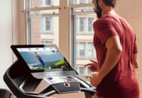 Man running on the Pro 9000 treadmill in his home.