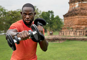 man using dumbbells to exercise