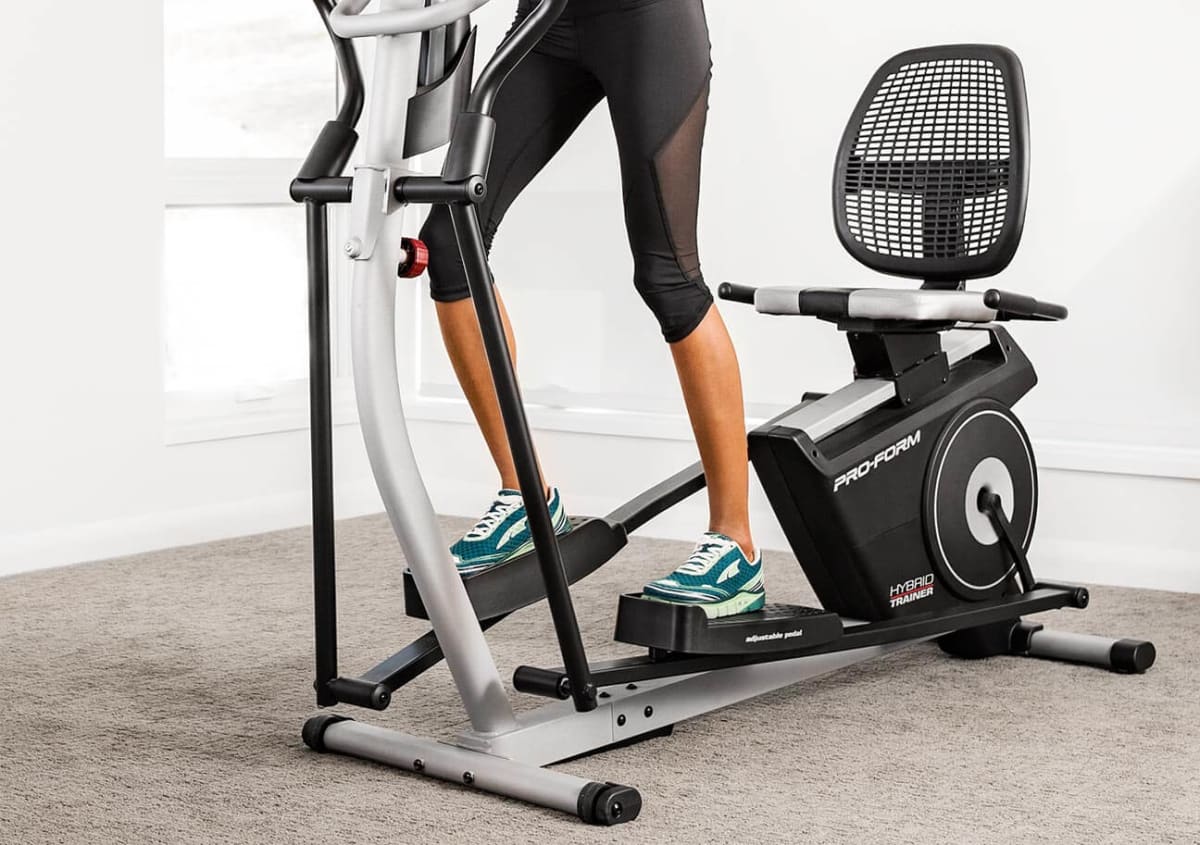 Woman using the hybrid trainer as an elliptical.