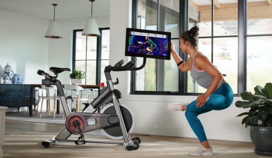 Woman stretching off the bike.