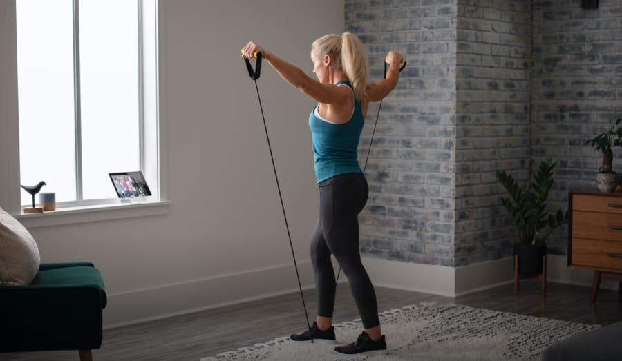 Woman working out using the Light Resistance Tube.