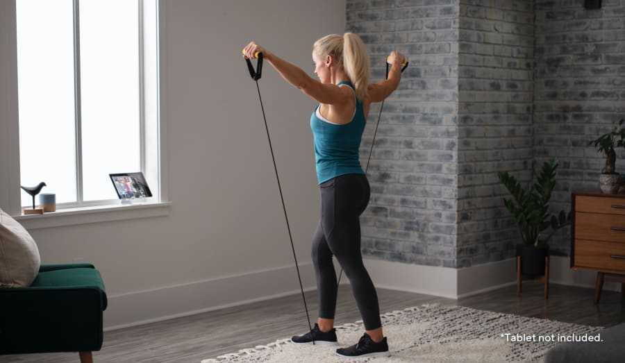 Woman working out using the Light Resistance Tube.