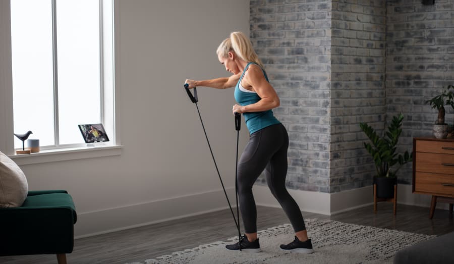 Woman working out using the Heavy Resistance Tube.