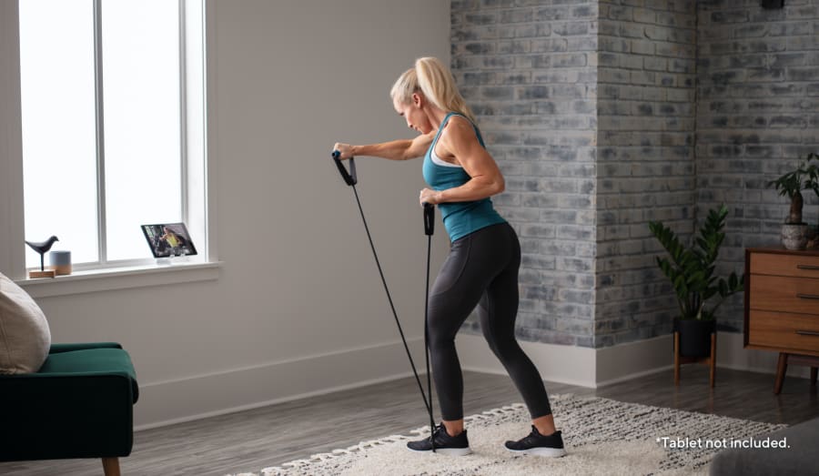 Woman working out using the Heavy Resistance Tube.