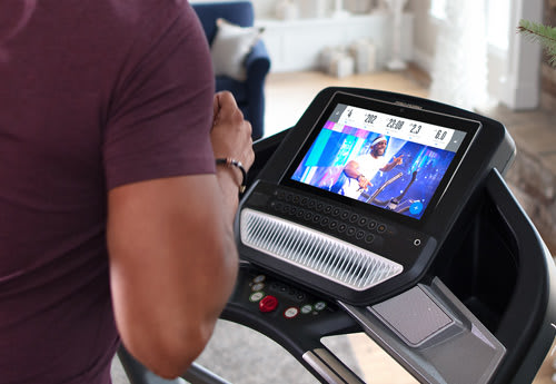 woman running on a treadmill in her home