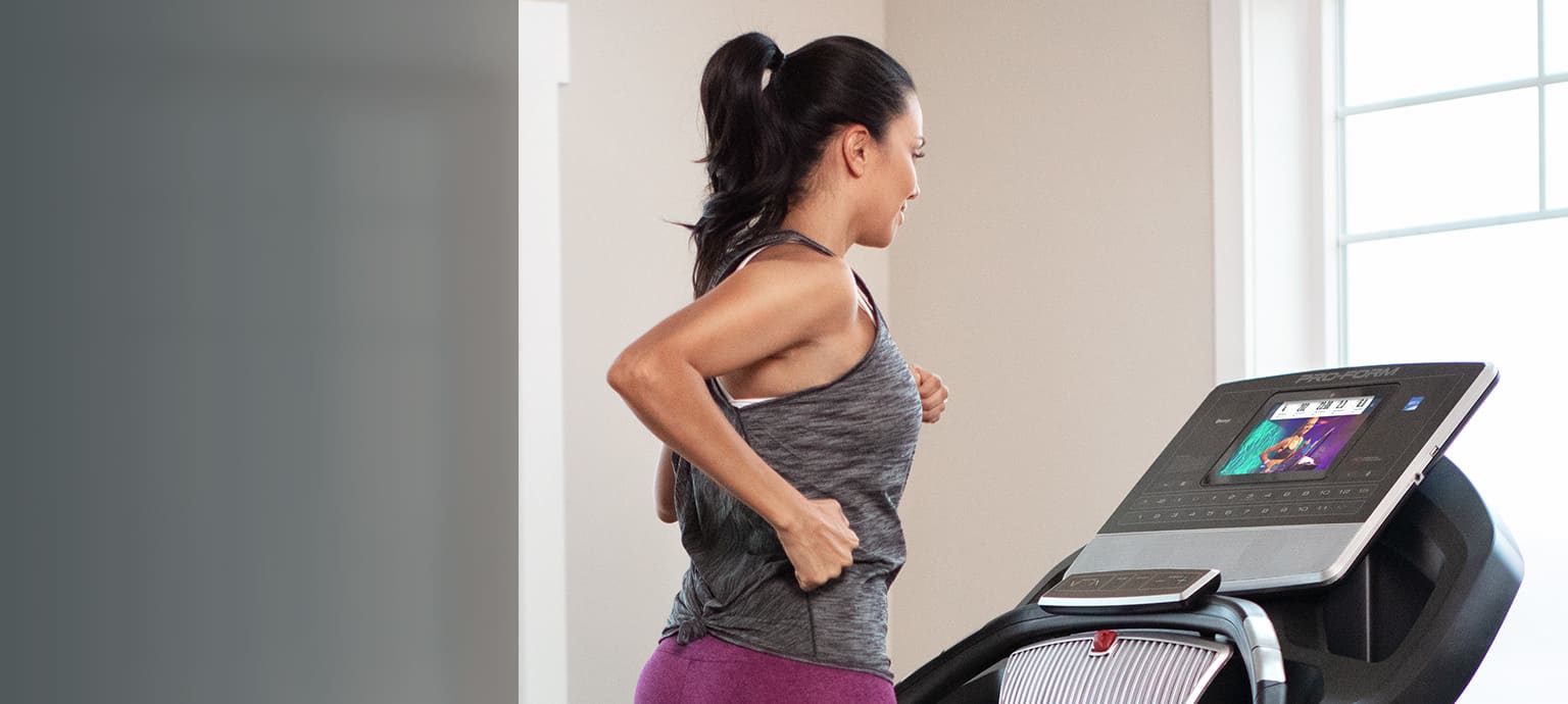 woman running on the SMART Pro 9000 treadmill large