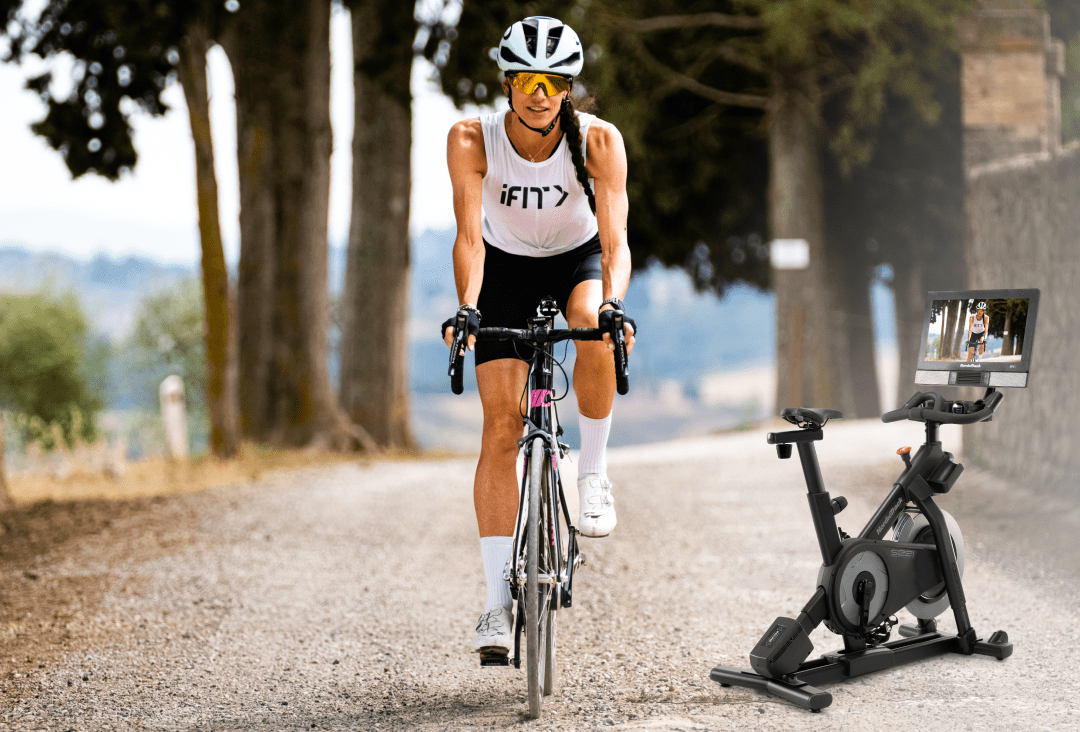 woman riding a road bike along side view image of a Nordictrack exercise bike