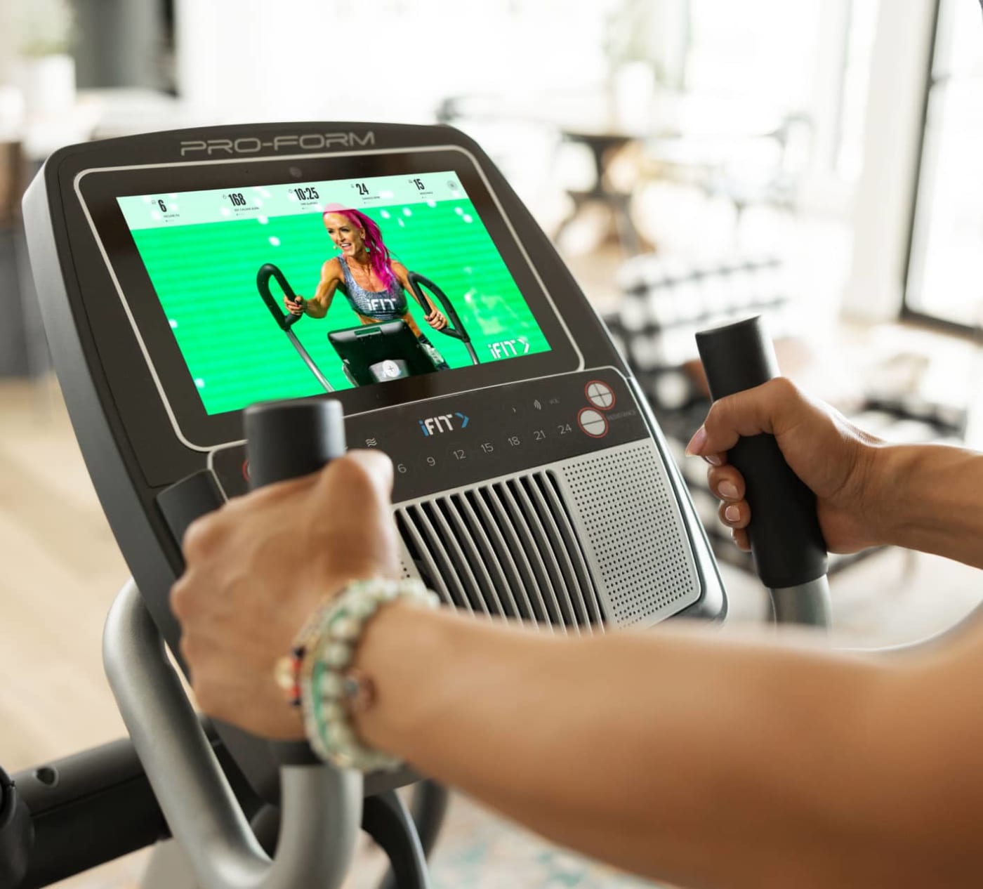 iFIT Trainer instructing a workout on the Carbon E10.