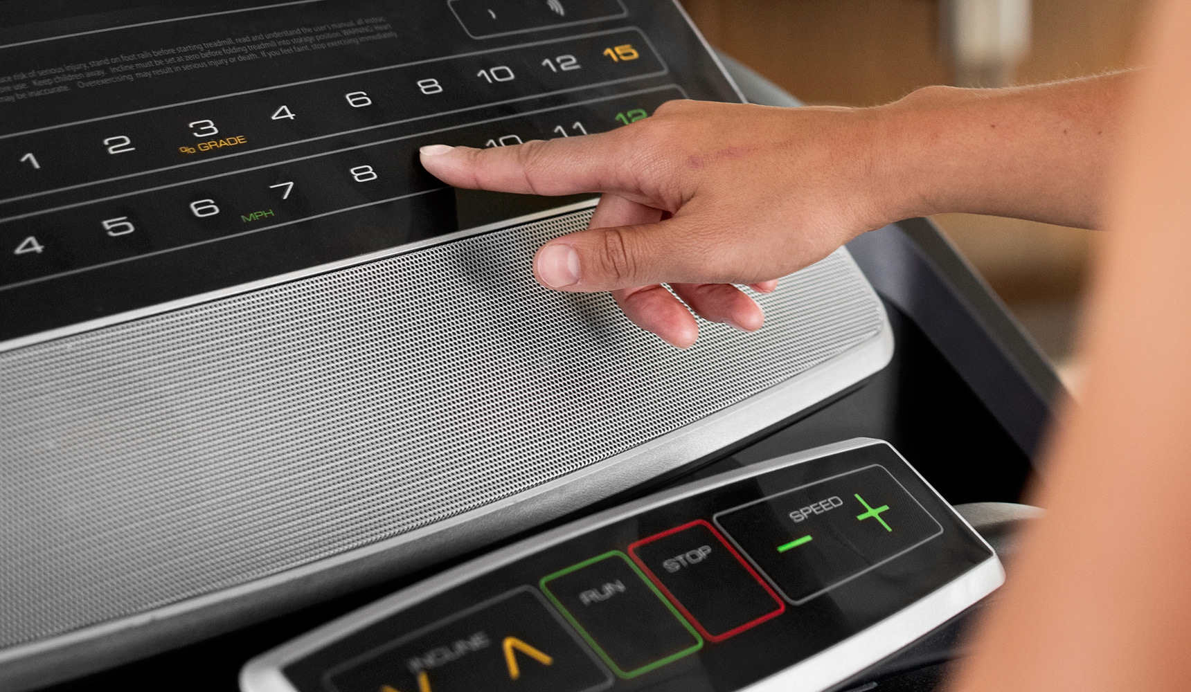 person pushing buttons on the console