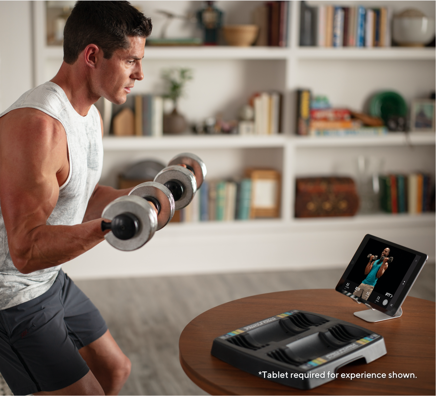Man working out with a trainer while using the 12.5 lb. Adjustable Dumbbell Set.
